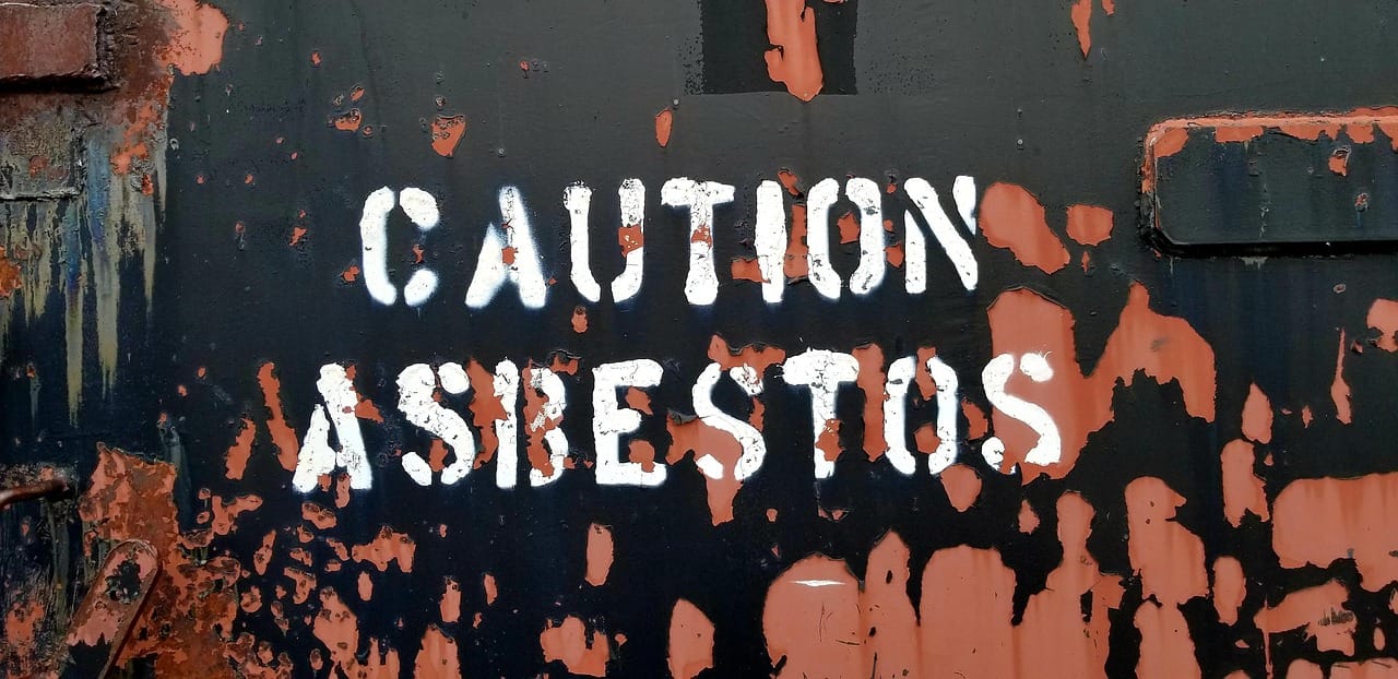 Sign stenciled 'Caution Asbestos'